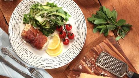 Inismara Sea Bass Fillet Wrapped in Prosciutto Ham, with Courgette, Lemon and Rocket Salad